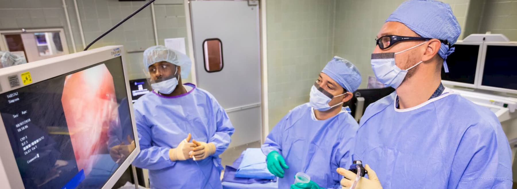 Group of physicians perform procedure.